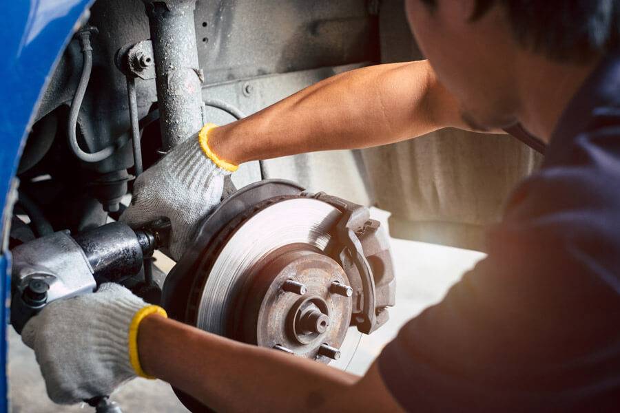 mechanic fixing car brakes