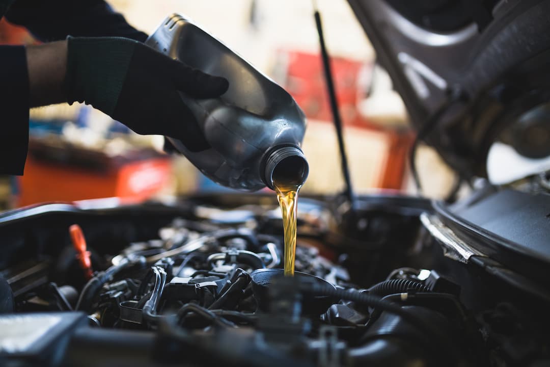 Topping up car engine oil during car servicing